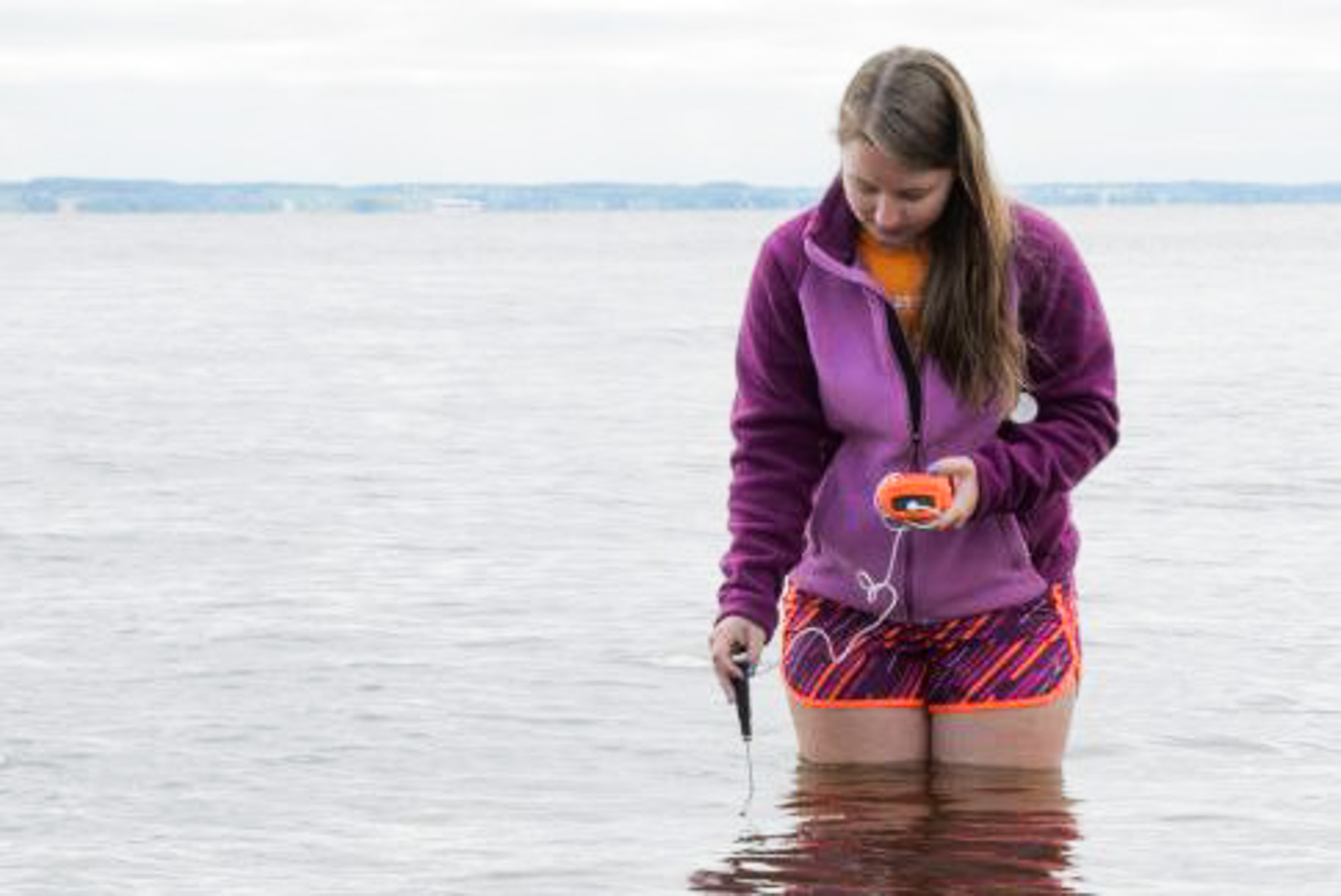 Image of intern from ERIC lab gathering water sample in Lake Winnebago
