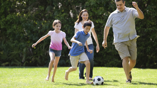 Family playing soccer